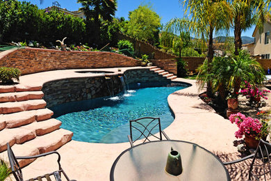 Pool - mid-sized mediterranean backyard stamped concrete and custom-shaped aboveground pool idea in Los Angeles