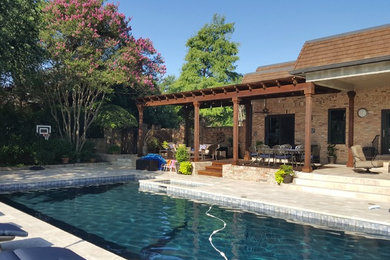 Pool - mid-sized traditional backyard stone and rectangular natural pool idea in Dallas