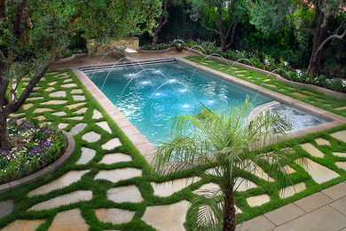 Inspiration for a mid-sized mediterranean backyard stone and rectangular lap pool fountain remodel in Los Angeles