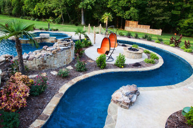 Photo of a large traditional back custom shaped lengths hot tub in Little Rock with concrete paving.