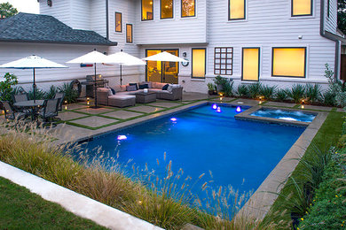 Pool - large modern backyard concrete paver and rectangular natural pool idea in Dallas