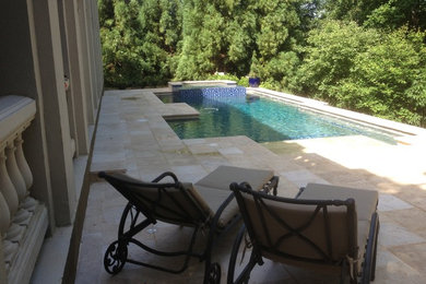 Small minimalist backyard stone and custom-shaped pool photo in Atlanta