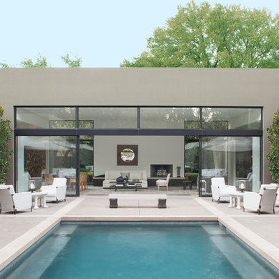 Trendy courtyard concrete and rectangular pool photo in Dallas