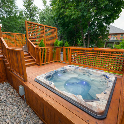 Mid-sized arts and crafts backyard custom-shaped hot tub photo in Toronto with decking