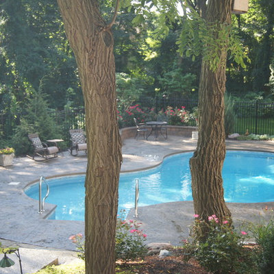 Inspiration for a mid-sized craftsman courtyard stamped concrete and custom-shaped aboveground pool remodel in Detroit