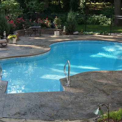 Inspiration for a mid-sized craftsman courtyard stamped concrete and custom-shaped aboveground pool remodel in Detroit