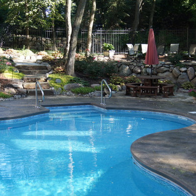 Inspiration for a mid-sized craftsman courtyard stamped concrete and custom-shaped aboveground pool remodel in Detroit