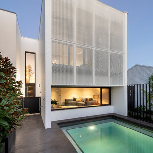 Design ideas for a contemporary rectangular pool in Perth with concrete slab.
