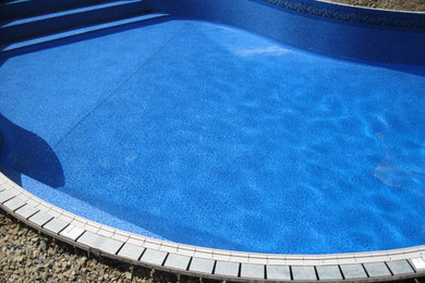 Design ideas for a medium sized back custom shaped swimming pool in Boston.