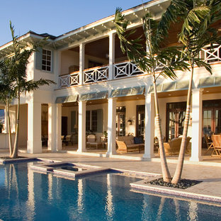 Photo of a tropical backyard custom-shaped pool in Miami.