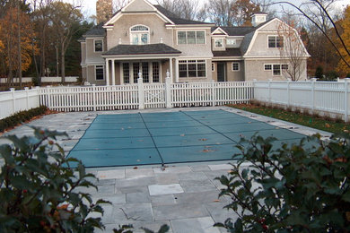 Inspiration for a large timeless courtyard stamped concrete and rectangular natural pool remodel in New York