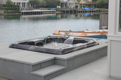 Large trendy concrete paver and rectangular natural hot tub photo in San Francisco