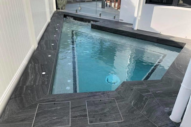 Small modern backyard custom-shaped pool in Gold Coast - Tweed.