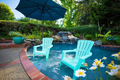 Example of a mid-sized classic backyard custom-shaped pool fountain design in Sacramento