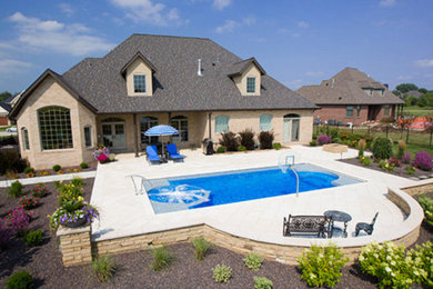 Mid-sized elegant backyard stone and rectangular lap hot tub photo in Chicago