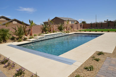 Inspiration for a large contemporary backyard rectangular infinity hot tub remodel in Las Vegas with decking