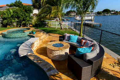 Large beach style backyard kidney-shaped lap hot tub photo in Tampa