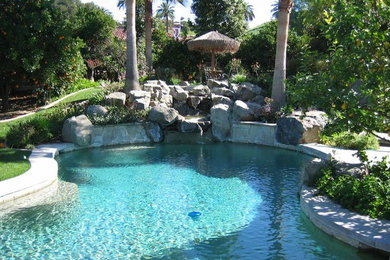Inspiration for a large transitional backyard stone and kidney-shaped pool fountain remodel in Los Angeles