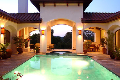 Inspiration for a mid-sized mediterranean courtyard tile and rectangular lap hot tub remodel in Austin