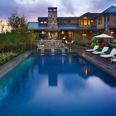 Example of a large trendy backyard concrete and rectangular lap hot tub design in Denver
