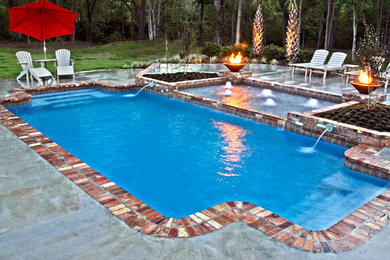 Large elegant backyard brick and rectangular lap pool fountain photo in Chicago