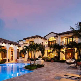 Photo of a large tropical custom-shaped pool in Miami with tile.