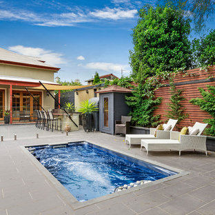 Victorian backyard rectangular lap pool in Melbourne with concrete pavers.