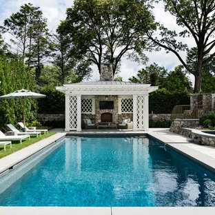 Classical RevivalThe lattice and columned pool pavilion with its stone fireplace