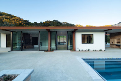 This is an example of a medium sized contemporary back rectangular lengths swimming pool in San Luis Obispo with concrete paving.