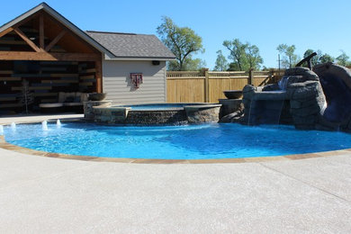Example of a mid-sized mountain style backyard kidney-shaped and concrete natural water slide design in Houston