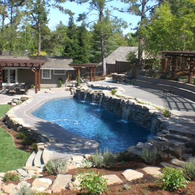 Mid-sized mountain style backyard stone and custom-shaped lap pool fountain photo in San Francisco