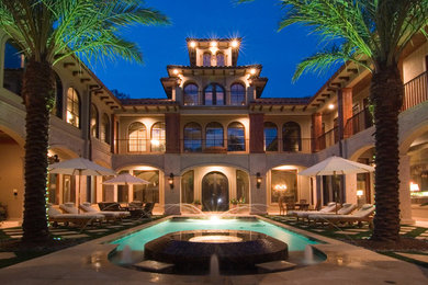 Large elegant courtyard stone and rectangular lap pool house photo in Houston