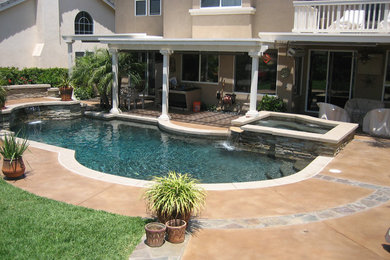 Pool fountain - large traditional backyard concrete paver and kidney-shaped lap pool fountain idea in San Diego