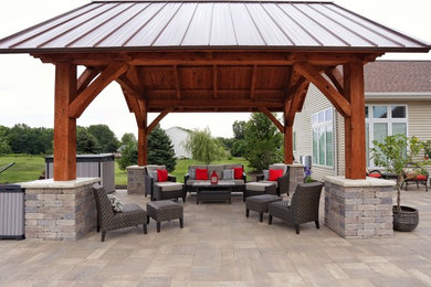 Huge elegant concrete paver patio photo in Other