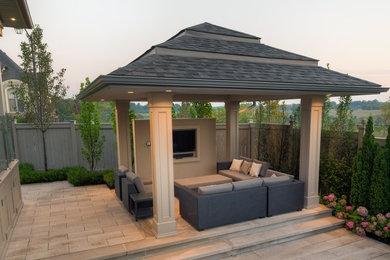 Example of a mid-sized trendy backyard rectangular pool house design in Toronto