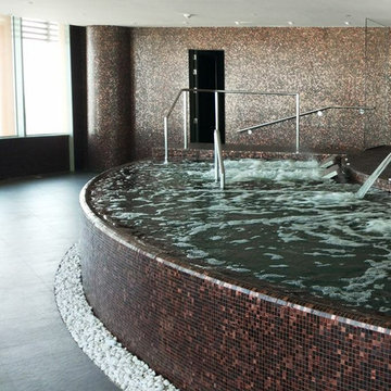 Contemporary indoor jacuzzi with recycled glass mosaic tile