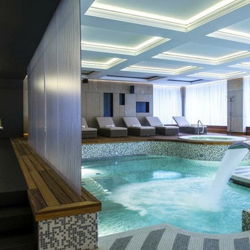 Contemporary indoor pool and spa with recycled glass mosaic