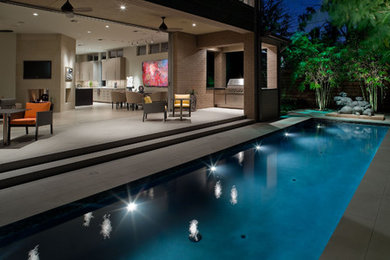 Small trendy side yard concrete paver and rectangular lap pool photo in Houston
