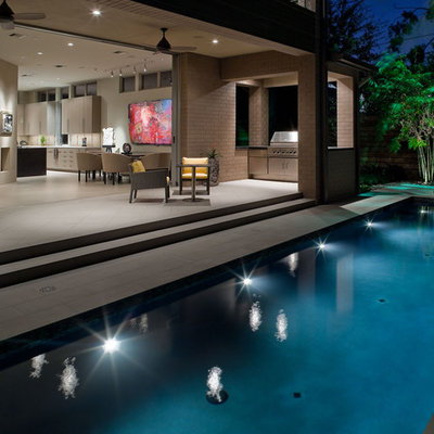 Small trendy side yard concrete paver and rectangular lap pool photo in Houston