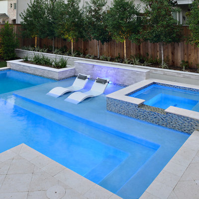 Inspiration for a small contemporary backyard stone and rectangular natural hot tub remodel in Houston