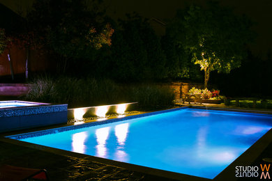 Mid-sized elegant backyard stone and rectangular lap hot tub photo in Oklahoma City