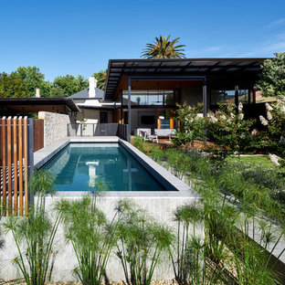 Photo of a contemporary backyard rectangular lap pool in Adelaide with concrete slab.