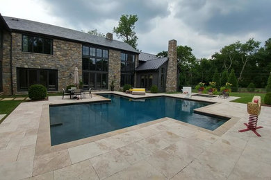Inspiration for a large modern backyard custom-shaped and tile lap hot tub remodel in Nashville