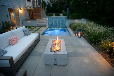 Patio - mid-sized contemporary backyard stone patio idea in New York
