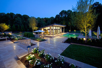 Photo of a large contemporary back rectangular natural swimming pool in DC Metro with a pool house and tiled flooring.