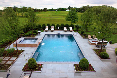 Mid-sized elegant backyard stone and rectangular pool photo in Chicago