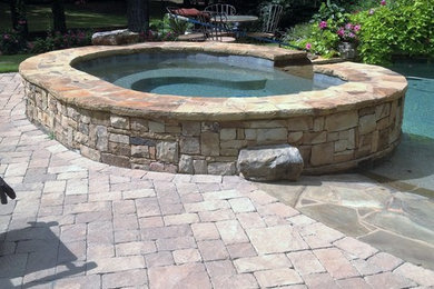 Large elegant backyard stone and custom-shaped natural pool fountain photo in Atlanta