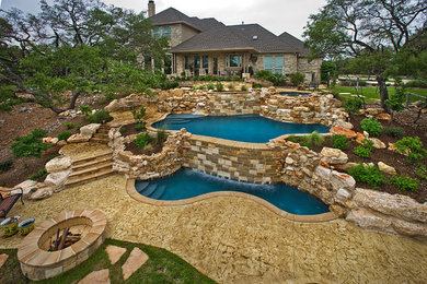 Large mountain style backyard concrete and custom-shaped natural pool fountain photo in Austin