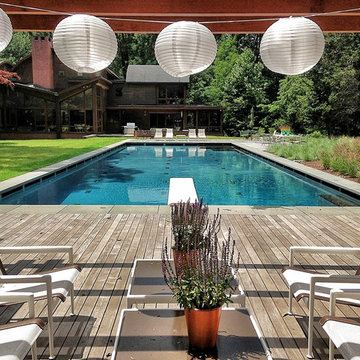 COUNTRY: Olympic-style swimming pool with wood decking + glass tile accents