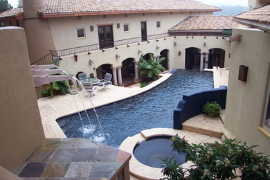 Inspiration for a timeless courtyard stone and custom-shaped pool remodel in Austin